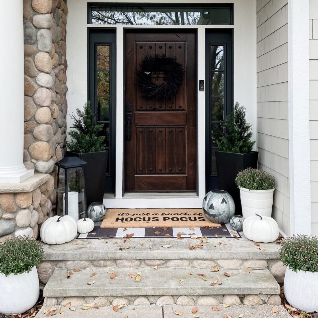Mix Evergreen Planters With White Pumpkins for a Quieter Halloween Look