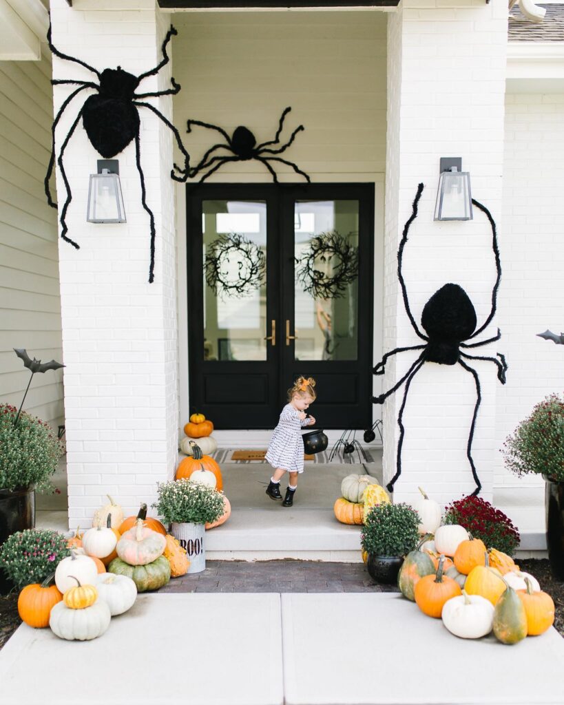 Use Rounded Mums to Ground Oversized Spider Decorations